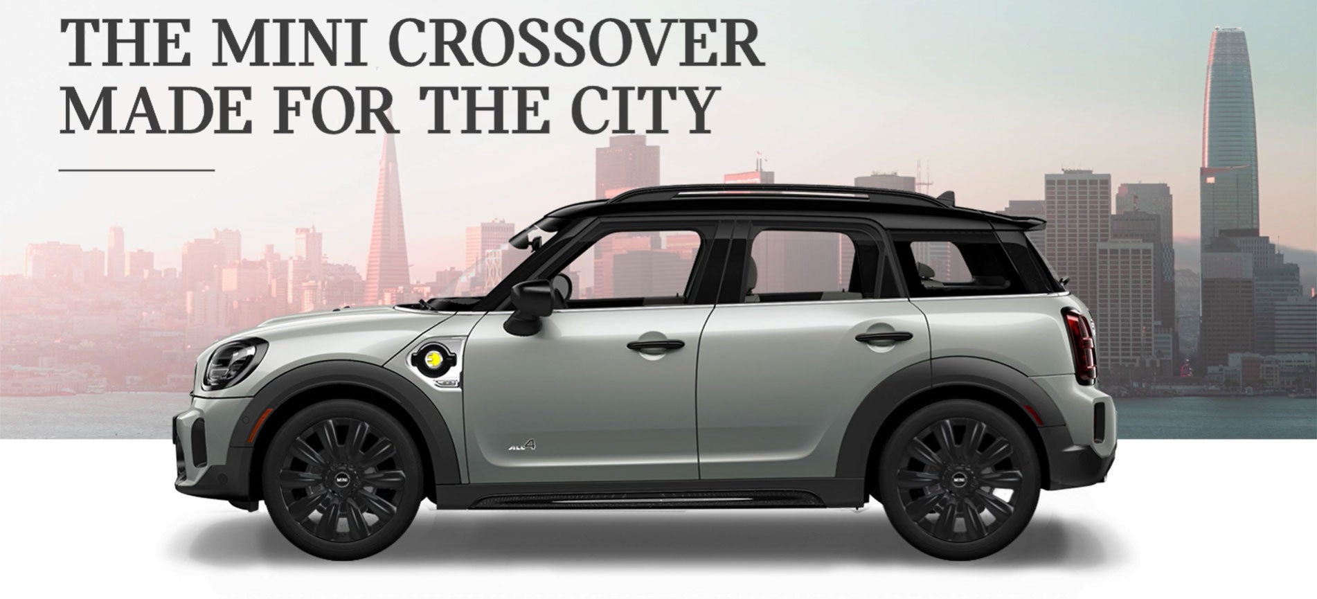 The MINI Cooper SE Countryman PHEV parked in front of a city scape. MINIDemo2 in Derwood MD