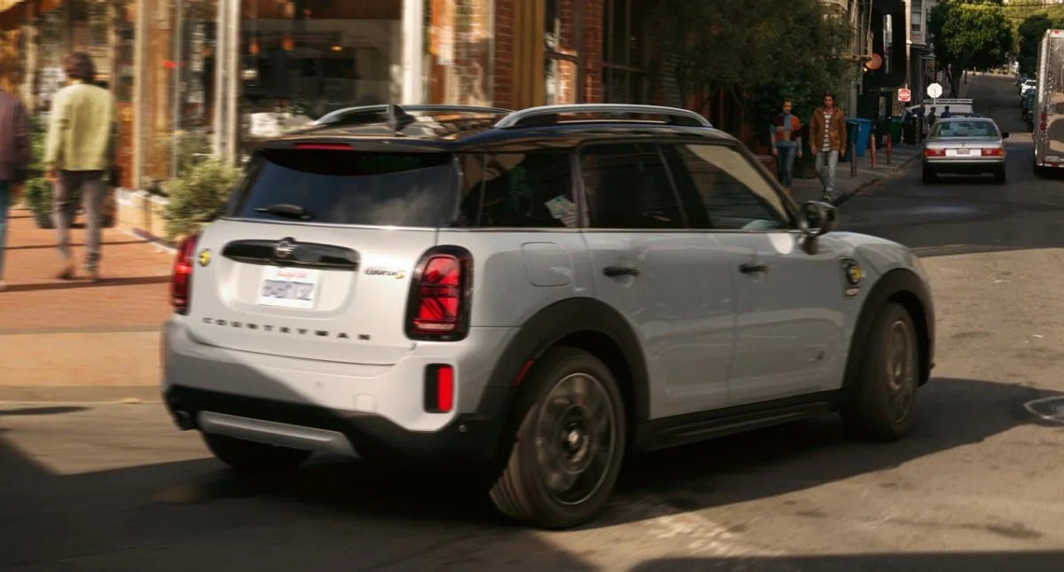 The MINI Cooper SE Countryman PHEV turning a corner in the city. MINIDemo2 in Derwood MD